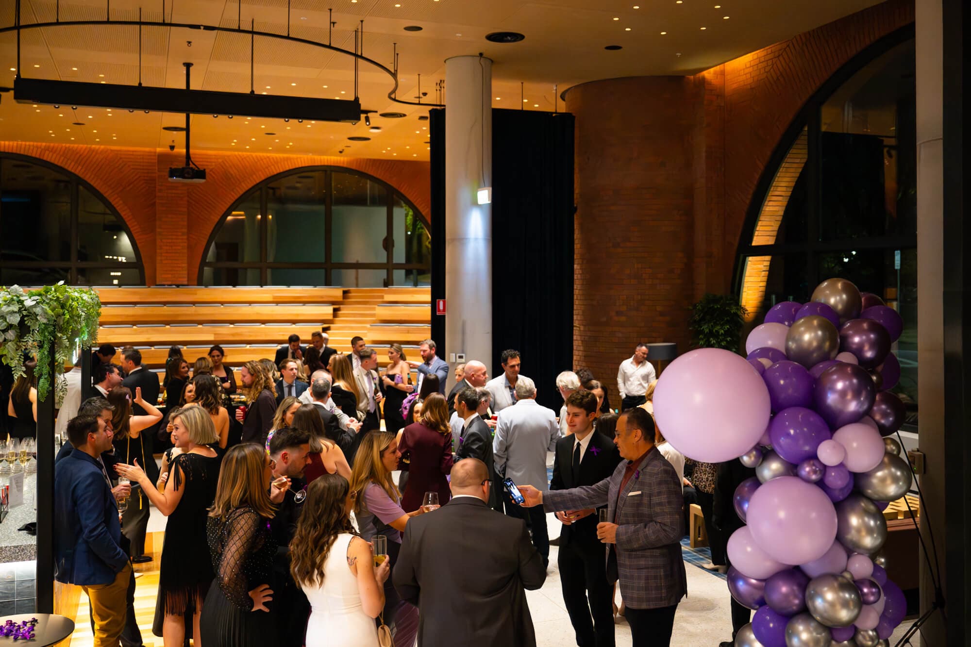 The dance floor filling up under the balloon garland